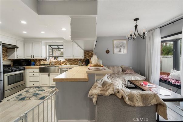 Chandelier, Interior, Kitchen, Living room, Recessed Lighting, Tile Countertops, Wood Texture Flooring
