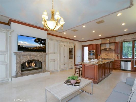 Chandelier, Dining room, Fireplace, Interior, Kitchen, Living room, Recessed Lighting, Stainless Steel Appliances