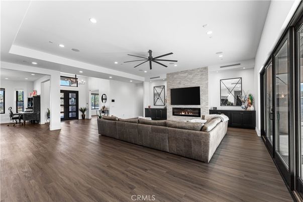Dining room, Fireplace, Interior, Living room, Recessed Lighting, Stone Walls, Wood Texture Flooring