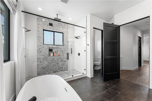Bathroom, Free Standing Baths, Glass Shower, Interior, Marble Walls, Recessed Lighting, Wood Texture Flooring