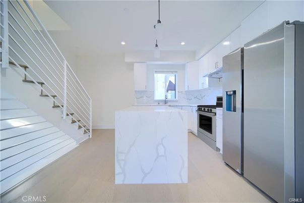 Interior, Kitchen, Marble Walls, Pendant Lights, Recessed Lighting, Stainless Steel Appliances, Wood Texture Flooring
