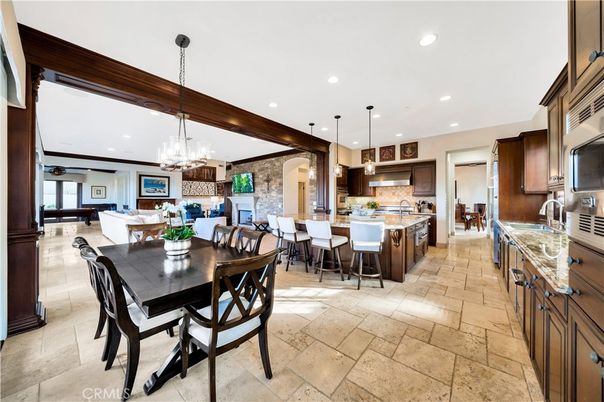 Chandelier, Dining room, Fireplace, Interior, Kitchen, Living room, Pendant Lights, Recessed Lighting, Stainless Steel Appliances