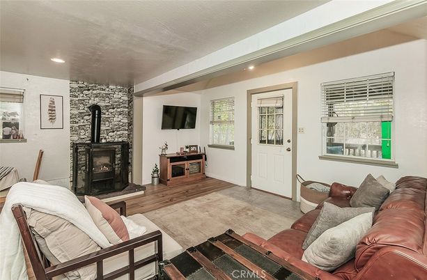 Fireplace, Interior, Living room, Recessed Lighting, Stone Walls, Wood Texture Flooring