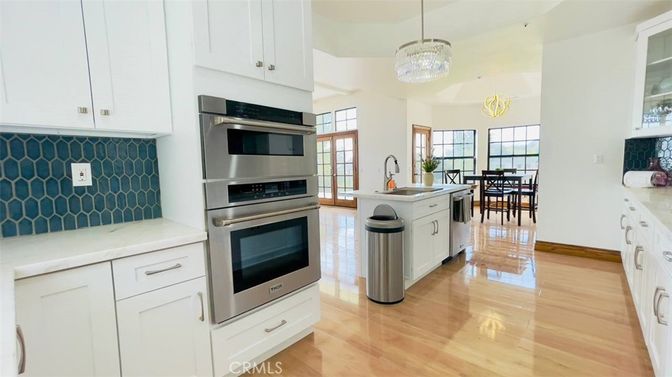 Chandelier, Dining room, Interior, Kitchen, Pendant Lights, Stainless Steel Appliances, Wood Texture Flooring