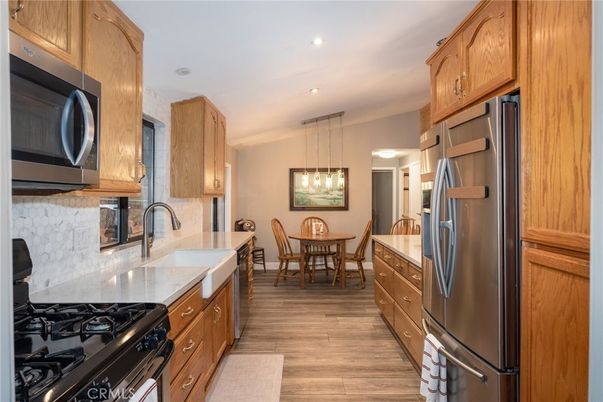 Dining room, Interior, Kitchen, Pendant Lights, Recessed Lighting, Stainless Steel Appliances, Wood Texture Flooring