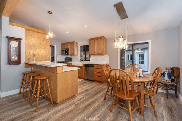 Dining room, Interior, Kitchen, Pendant Lights, Recessed Lighting, Stainless Steel Appliances, Wood Texture Flooring