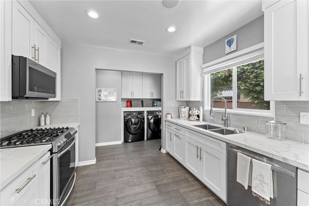 Interior, Kitchen, Recessed Lighting, Washer, Wood Texture Flooring