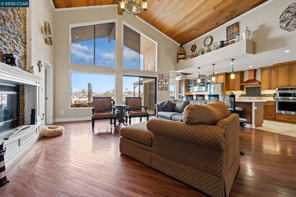 Fireplace, Interior, Kitchen, Living room, Pendant Lights, Recessed Lighting, Stainless Steel Appliances, Wooden Ceilings, Wood Texture Flooring