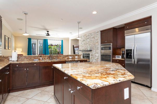 Fireplace, Interior, Kitchen, Pendant Lights, Recessed Lighting, Stainless Steel Appliances, Stone Walls