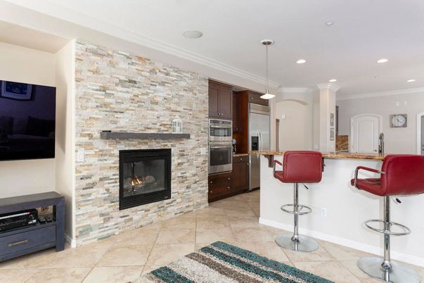 Fireplace, Interior, Kitchen, Pendant Lights, Recessed Lighting, Stainless Steel Appliances, Stone Walls
