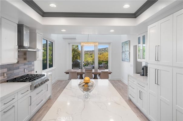 Chandelier, Dining room, Interior, Kitchen, Marble, Pendant Lights, Recessed Lighting, Stainless Steel Appliances, Wood Texture Flooring