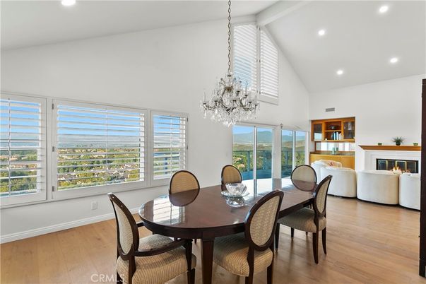 Chandelier, Dining room, Fireplace, Interior, Living room, Pendant Lights, Recessed Lighting, Wood Texture Flooring