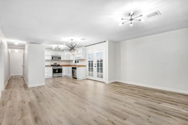 Empty room, Interior, Kitchen, Pendant Lights, Stainless Steel Appliances, Wood Texture Flooring