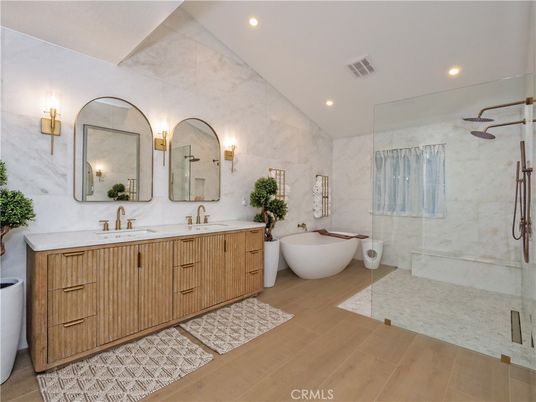 Bathroom, Dual Sink Vanities, Free Standing Baths, Glass Shower, Interior, Marble Walls, Recessed Lighting, Wood Texture Flooring