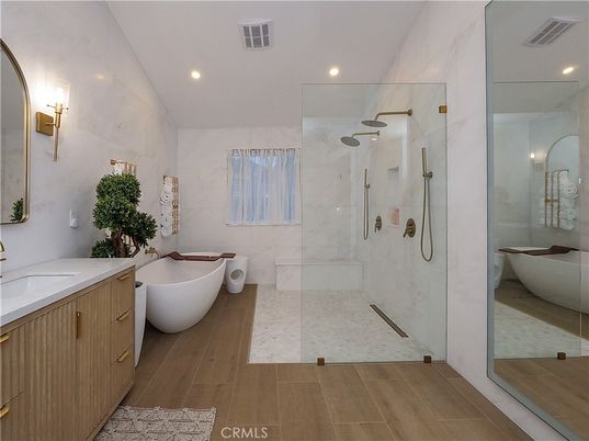 Bathroom, Dual Sink Vanities, Free Standing Baths, Glass Shower, Interior, Marble Walls, Recessed Lighting, Wood Texture Flooring