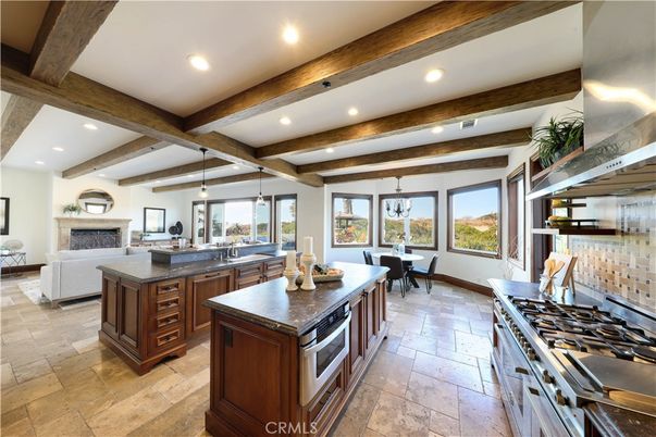 Chandelier, Dining room, Fireplace, Interior, Kitchen, Living room, Pendant Lights, Recessed Lighting, Stainless Steel Appliances, Wooden Beams