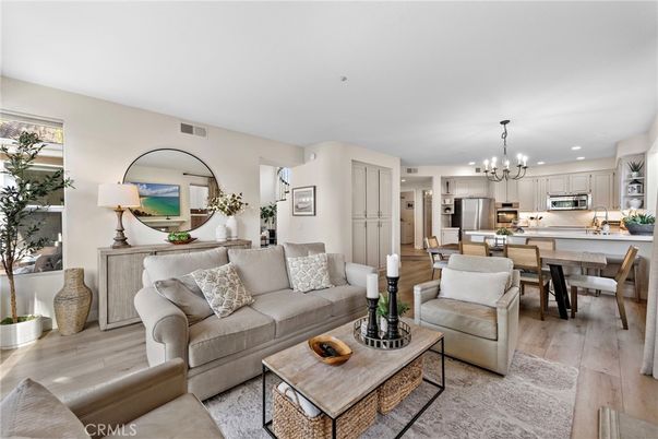 Chandelier, Dining room, Interior, Kitchen, Living room, Pendant Lights, Recessed Lighting, Stainless Steel Appliances, Wood Texture Flooring