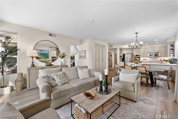 Chandelier, Dining room, Interior, Kitchen, Living room, Pendant Lights, Recessed Lighting, Stainless Steel Appliances, Wood Texture Flooring