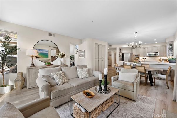 Chandelier, Dining room, Interior, Kitchen, Living room, Pendant Lights, Recessed Lighting, Stainless Steel Appliances, Wood Texture Flooring