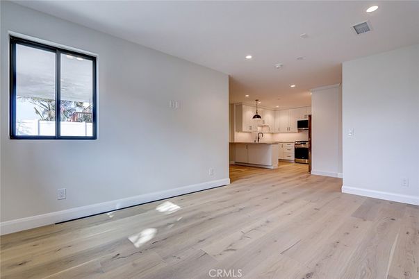 Empty room, Interior, Kitchen, Pendant Lights, Recessed Lighting, Stainless Steel Appliances, Wood Texture Flooring