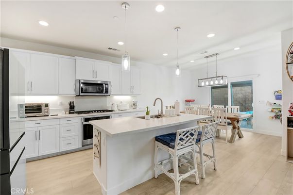Dining room, Interior, Kitchen, Pendant Lights, Recessed Lighting, Stainless Steel Appliances, Wood Texture Flooring