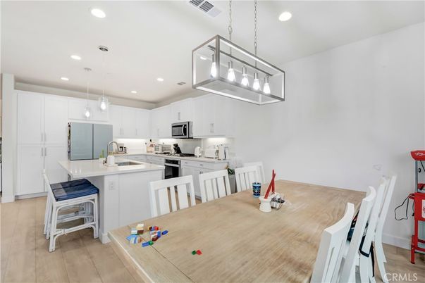 Dining room, Interior, Kitchen, Pendant Lights, Recessed Lighting, Stainless Steel Appliances, Wood Texture Flooring