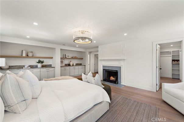 Bedroom, Chandelier, Fireplace, Interior, Recessed Lighting, Wood Texture Flooring