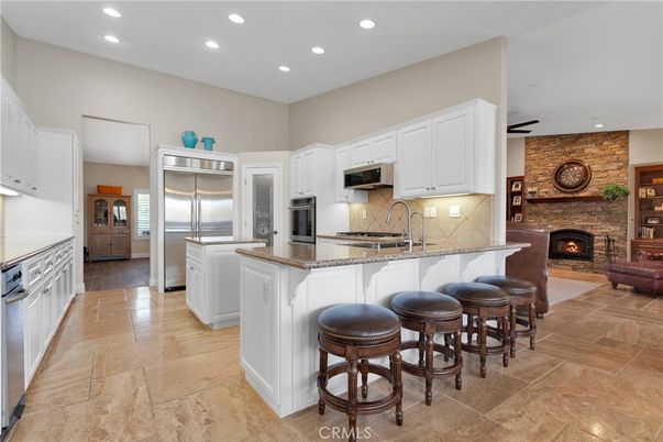 Fireplace, Interior, Kitchen, Recessed Lighting, Stainless Steel Appliances, Stone Walls