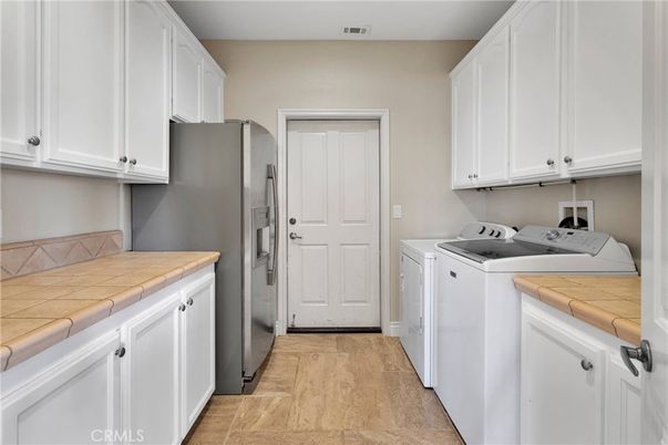 Interior, Kitchen, Tile Countertops, Washer, Wood Texture Flooring