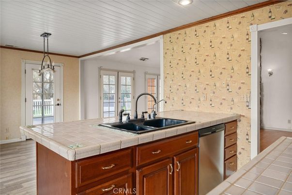 Interior, Kitchen, Pendant Lights, Recessed Lighting, Stainless Steel Appliances, Tile Countertops, Wood Texture Flooring