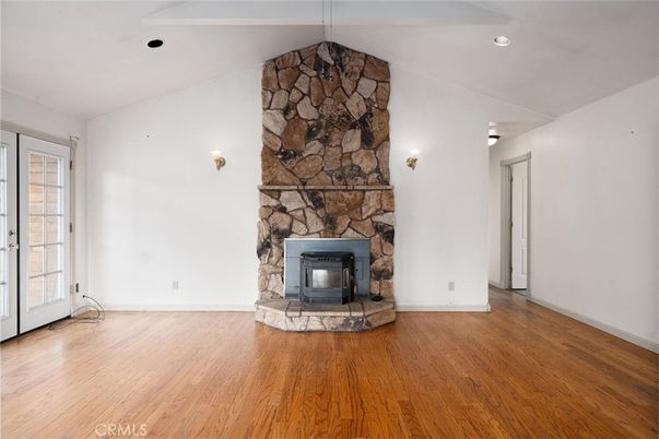 Empty room, Fireplace, Interior, Recessed Lighting, Stone Walls, Wood Texture Flooring