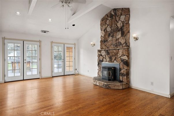 Empty room, Fireplace, Interior, Recessed Lighting, Stone Walls, Wood Texture Flooring