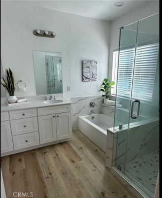 Bathroom, Dual Sink Vanities, Glass Shower, Interior, Marble Walls, Wood Texture Flooring