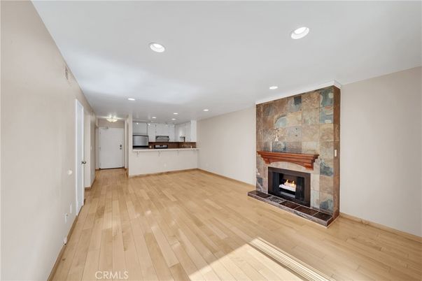 Empty room, Fireplace, Interior, Kitchen, Recessed Lighting, Stone Walls, Wood Texture Flooring