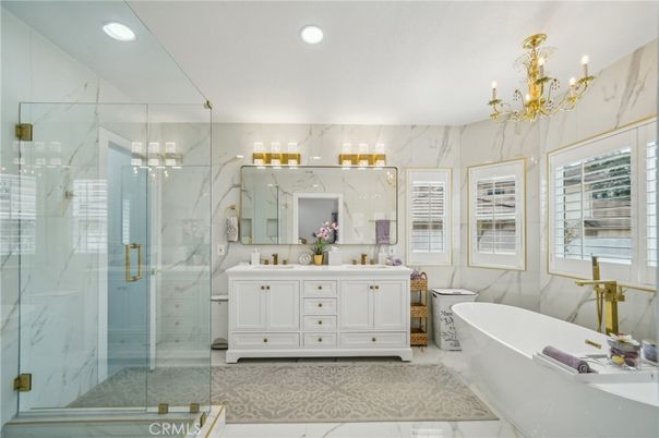 Bathroom, Chandelier, Dual Sink Vanities, Free Standing Baths, Glass Shower, Interior, Marble Walls, Recessed Lighting