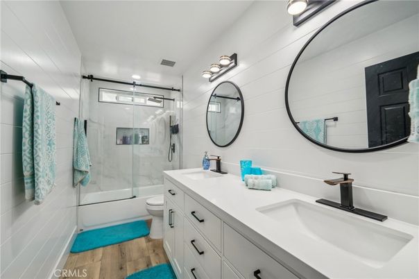 Bathroom, Dual Sink Vanities, Glass Shower, Interior, Recessed Lighting, Wood Texture Flooring