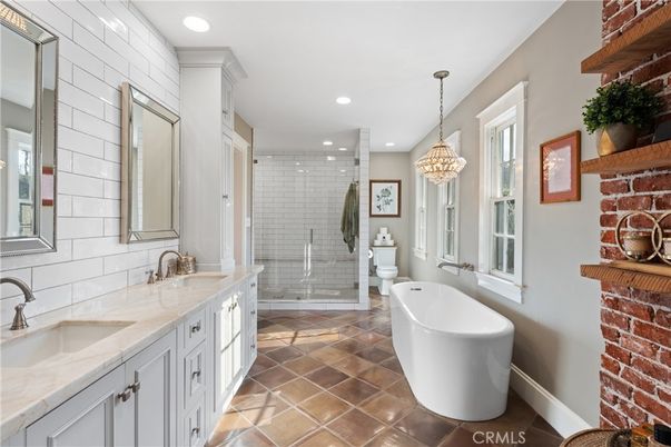 Bathroom, Chandelier, Dual Sink Vanities, Free Standing Baths, Glass Shower, Interior, Pendant Lights, Recessed Lighting, Stone Walls