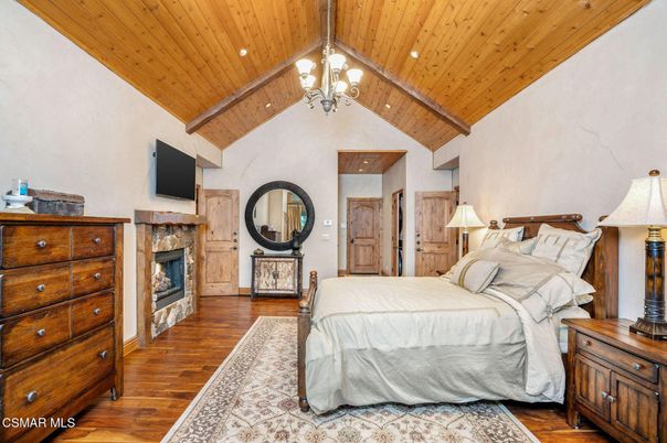 Bedroom, Chandelier, Fireplace, Interior, Recessed Lighting, Wooden Beams, Wooden Ceilings, Wood Texture Flooring