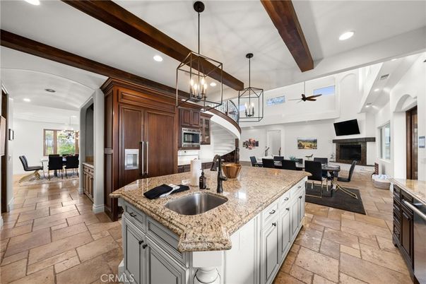 Chandelier, Dining room, Fireplace, Interior, Kitchen, Living room, Pendant Lights, Recessed Lighting, Stainless Steel Appliances, Wooden Beams