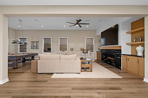 Billiard Table, Fireplace, Game Room, Interior, Living room, Pendant Lights, Recessed Lighting, Wood Texture Flooring