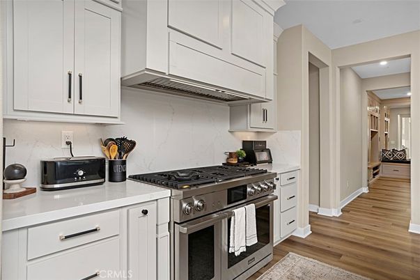 Interior, Kitchen, Marble Walls, Recessed Lighting, Stainless Steel Appliances, Wood Texture Flooring