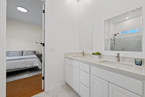 Bathroom, Bedroom, Dual Sink Vanities, Interior, Marble, Marble Walls, Recessed Lighting, Wood Texture Flooring