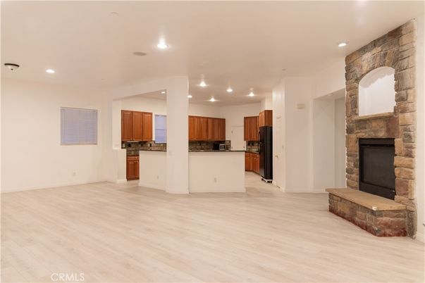 Empty room, Fireplace, Interior, Kitchen, Recessed Lighting, Stone Walls, Wood Texture Flooring