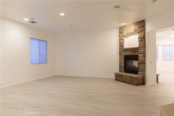Empty room, Fireplace, Interior, Recessed Lighting, Stone Walls, Wood Texture Flooring