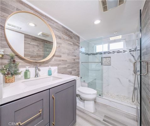 Bathroom, Dual Sink Vanities, Glass Shower, Interior, Marble Walls, Recessed Lighting, Wood Texture Flooring, Wooden Walls