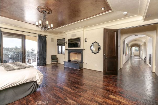 Bedroom, Chandelier, Fireplace, Interior, Recessed Lighting, Wood Texture Flooring