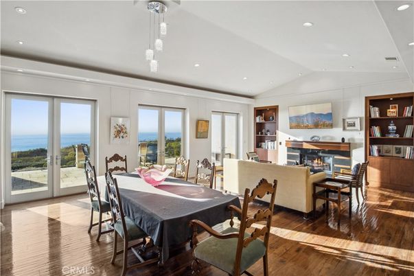 Dining room, Fireplace, Interior, Living room, Pendant Lights, Recessed Lighting, Water, Wood Texture Flooring