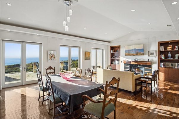 Dining room, Fireplace, Interior, Living room, Pendant Lights, Recessed Lighting, Water, Wood Texture Flooring