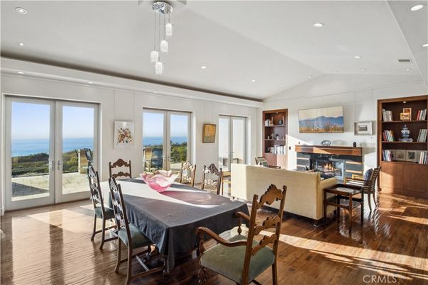 Dining room, Fireplace, Interior, Living room, Pendant Lights, Recessed Lighting, Water, Wood Texture Flooring