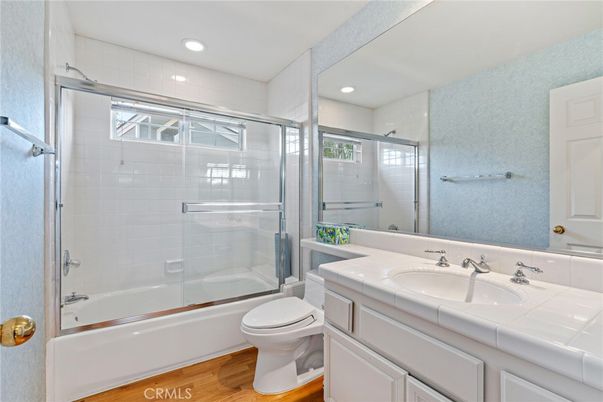 Bathroom, Glass Shower, Interior, Recessed Lighting, Tile Countertops, Wood Texture Flooring